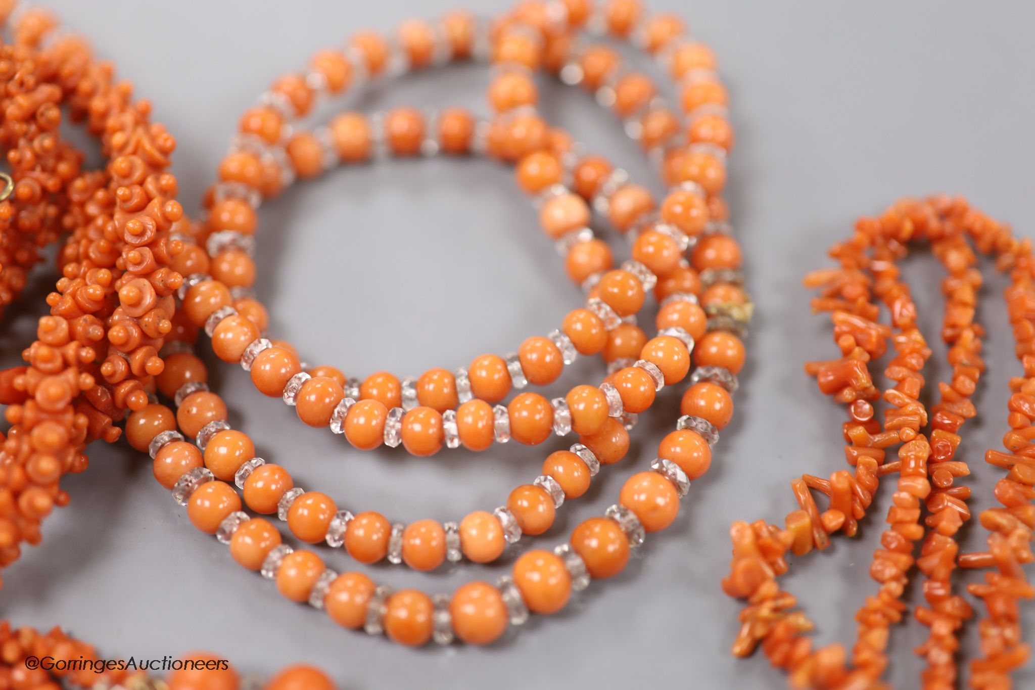 Four assorted coral bead necklaces, largest 148cm and a coral bead bracelet.